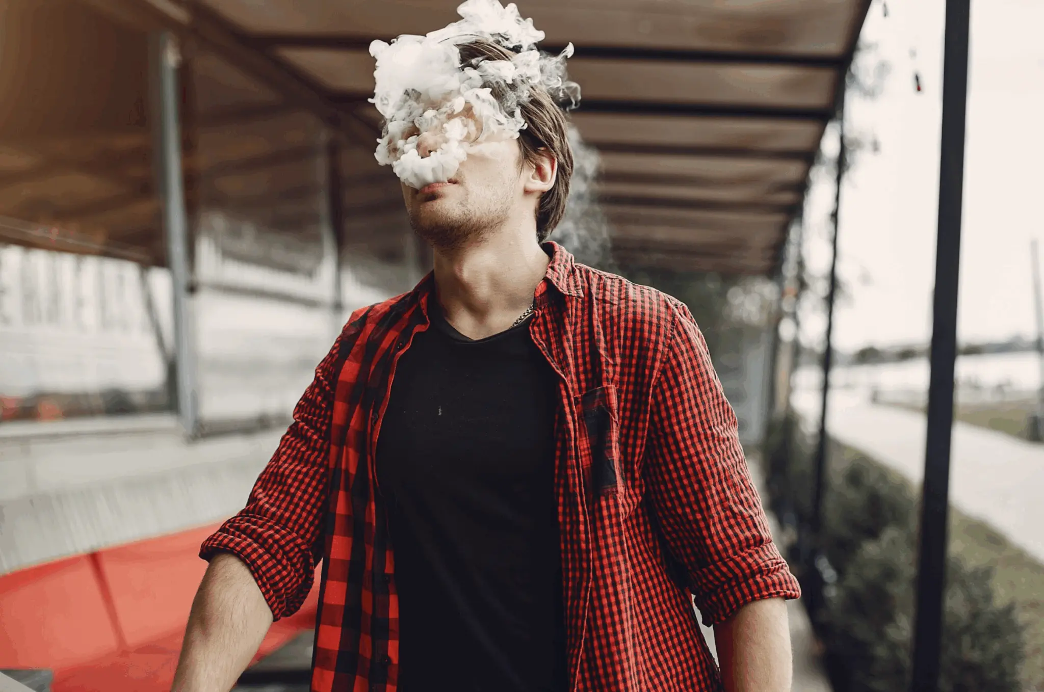 Man smoking an e-cigarette, reflecting concerns about whether vaping can cause erectile dysfunction.