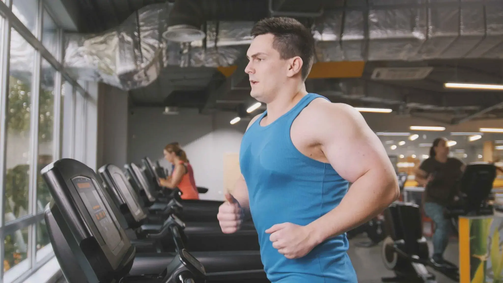 Man running on a treadmill at the gym, highlighting how exercise combined with GLP-1 medications can positively impact weight loss and overall wellbeing.