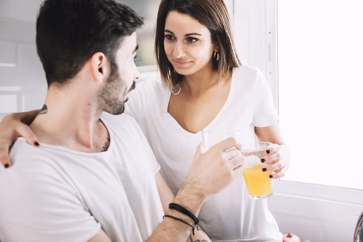 couple with juice looking each other