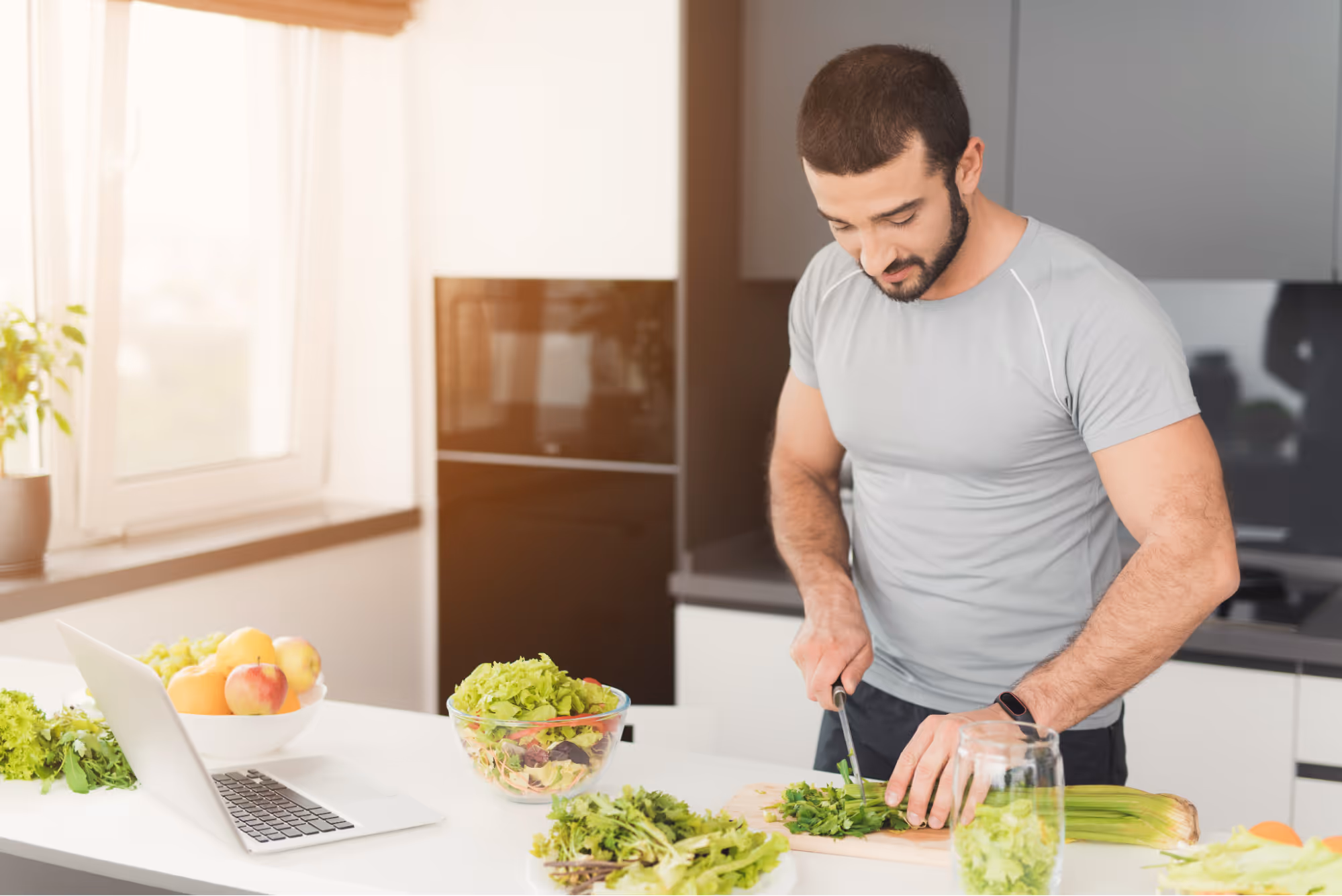 Man preparing a healthy meal with fresh vegetables in a modern kitchen, supporting semaglutide weight loss results with proper nutrition.
