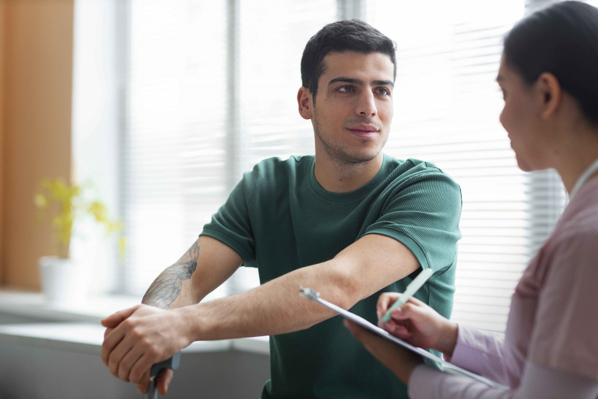 Man consulting with a medical professional about his testosterone levels and whether they are in a normal range for his age.