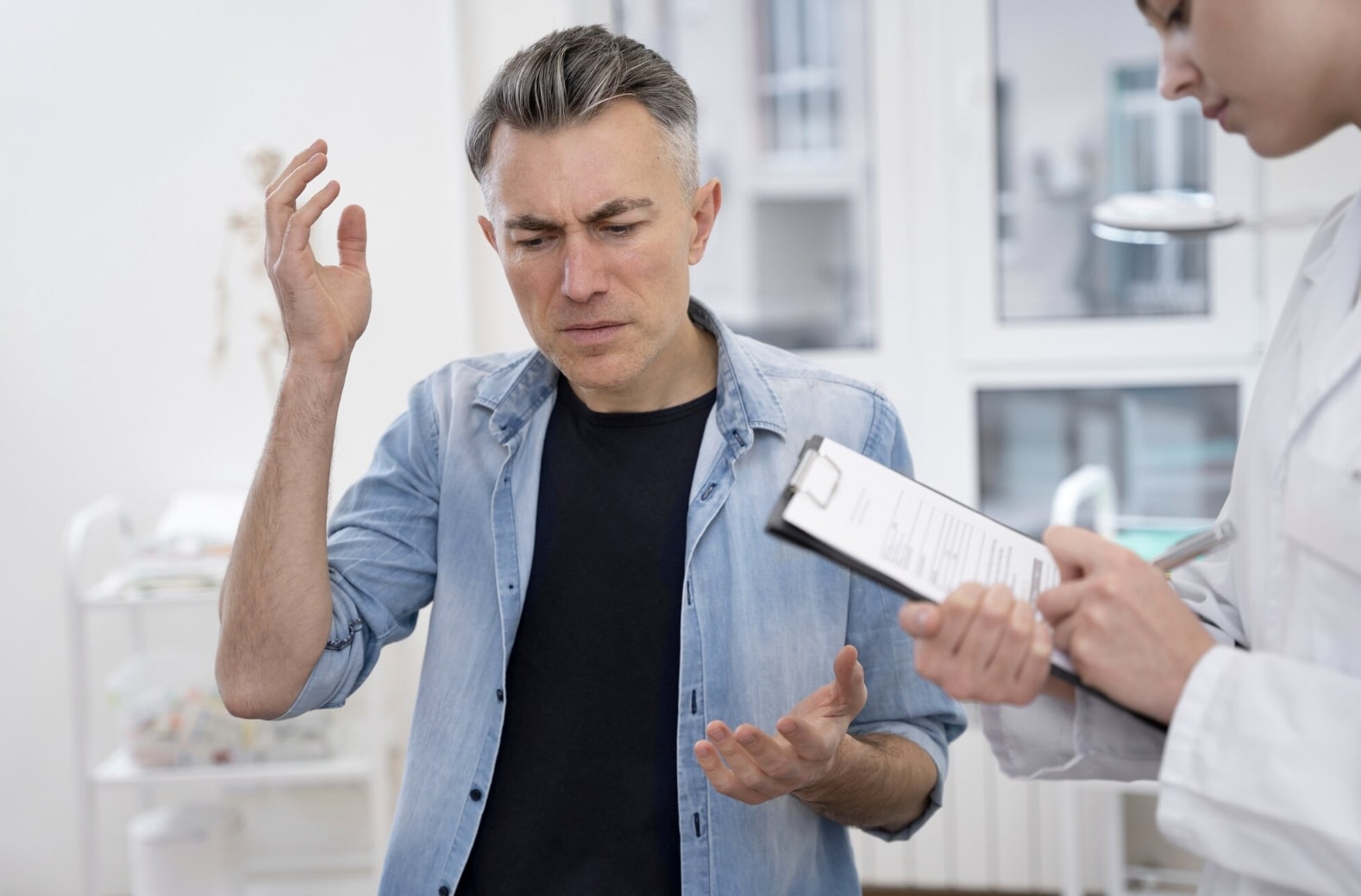 A man consulting with his doctor about sexual health, portraying the process of learning about advanced ED solutions and modern treatment approaches.