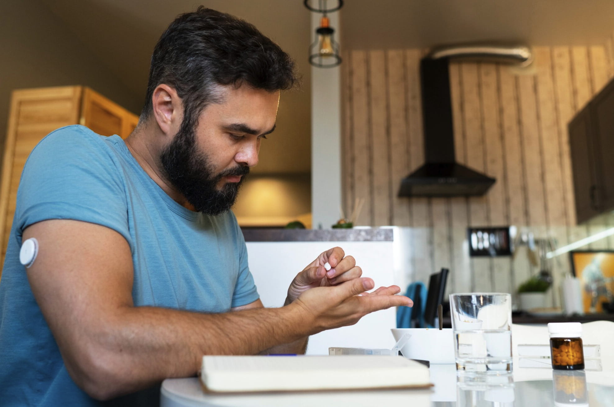 Man with diabetes holding a pill at home, reflecting how blood sugar control and diabetes can impact erectile function and sexual health.