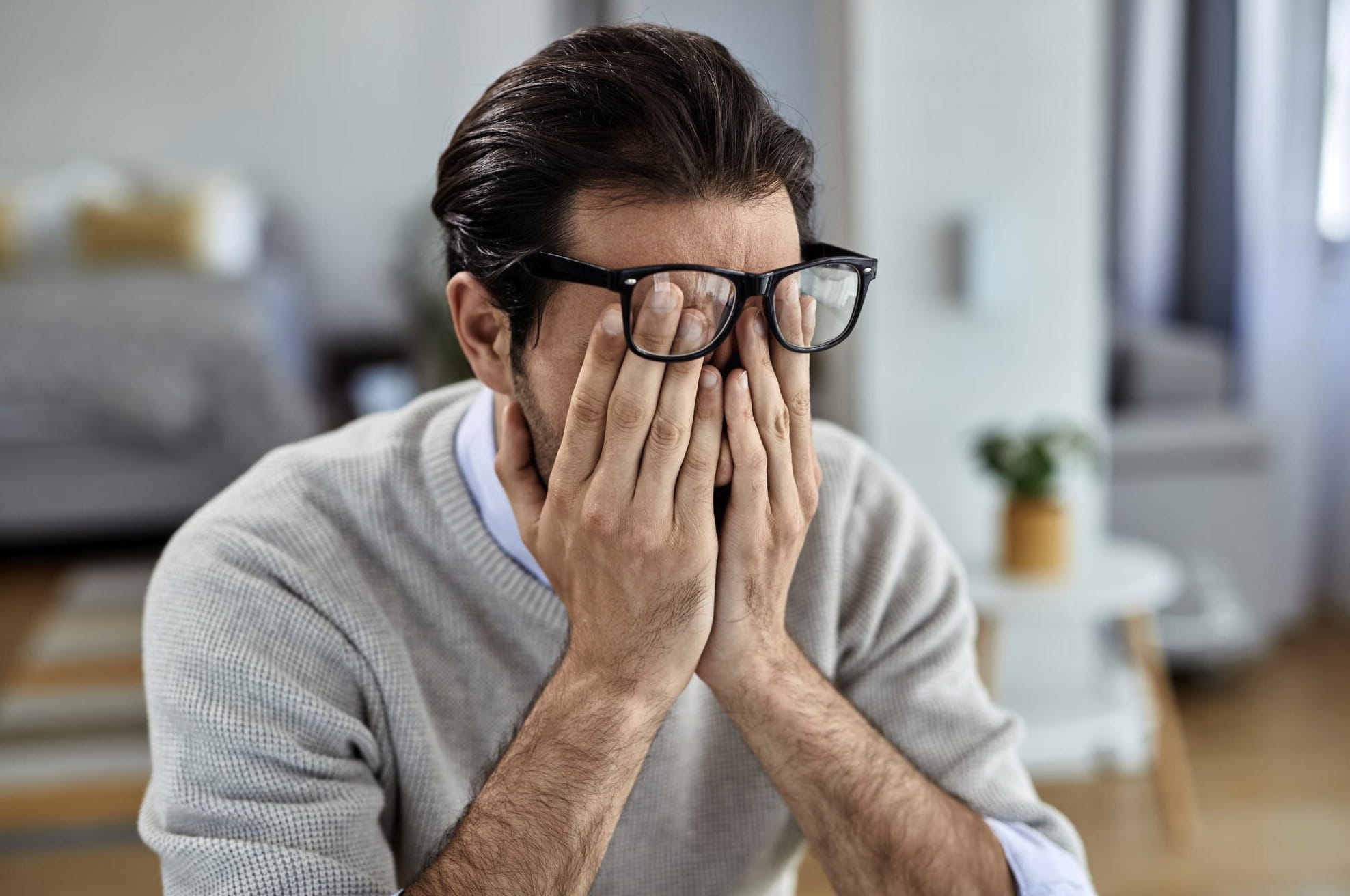 Stressed man sitting at his office desk, illustrating how chronic stress and mental fatigue can contribute to erectile dysfunction in men.