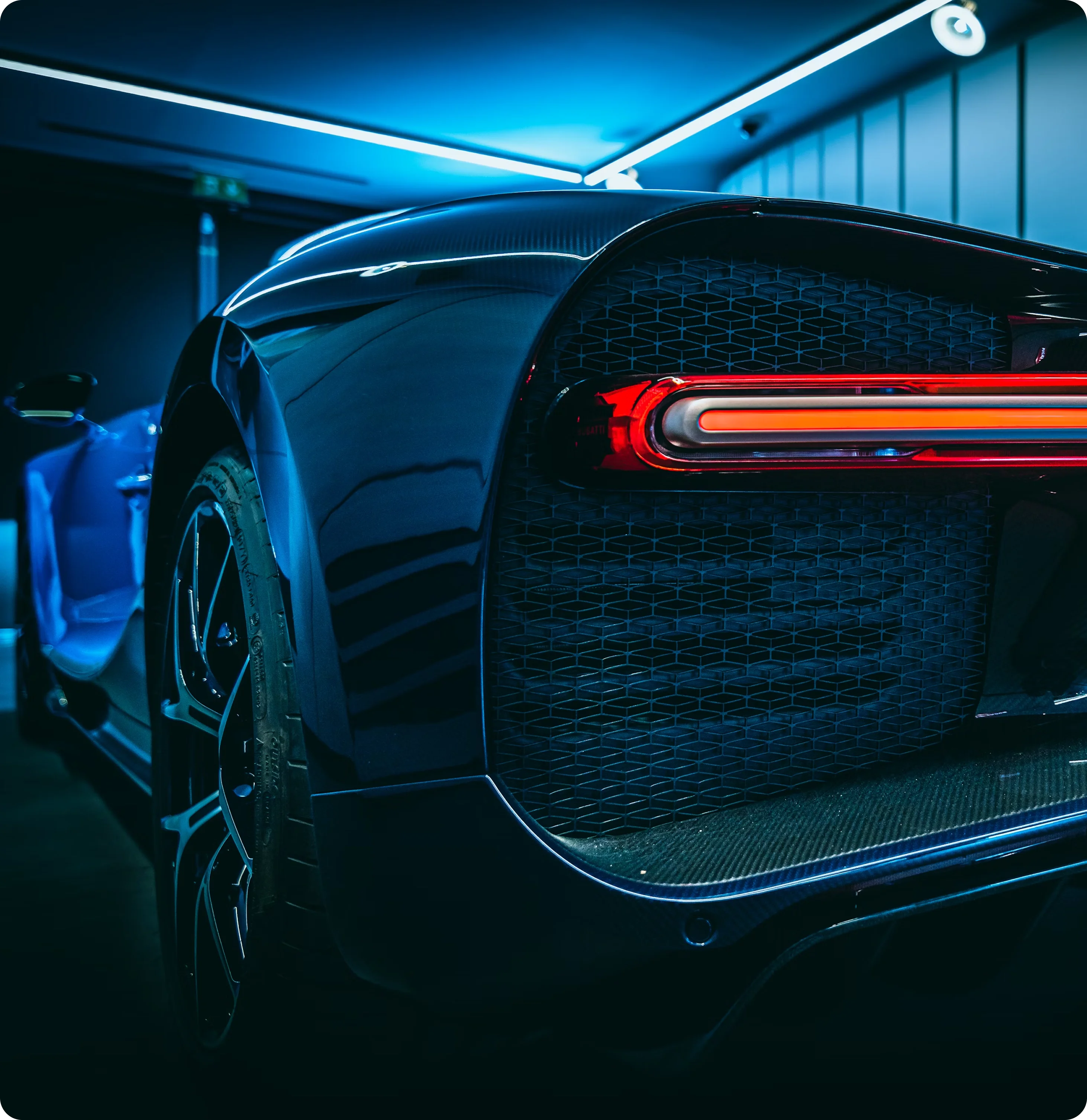 Luxury sports car rear view with LED tail lights and performance tires — get the best luxury car deals with Negotiate Best Deal.