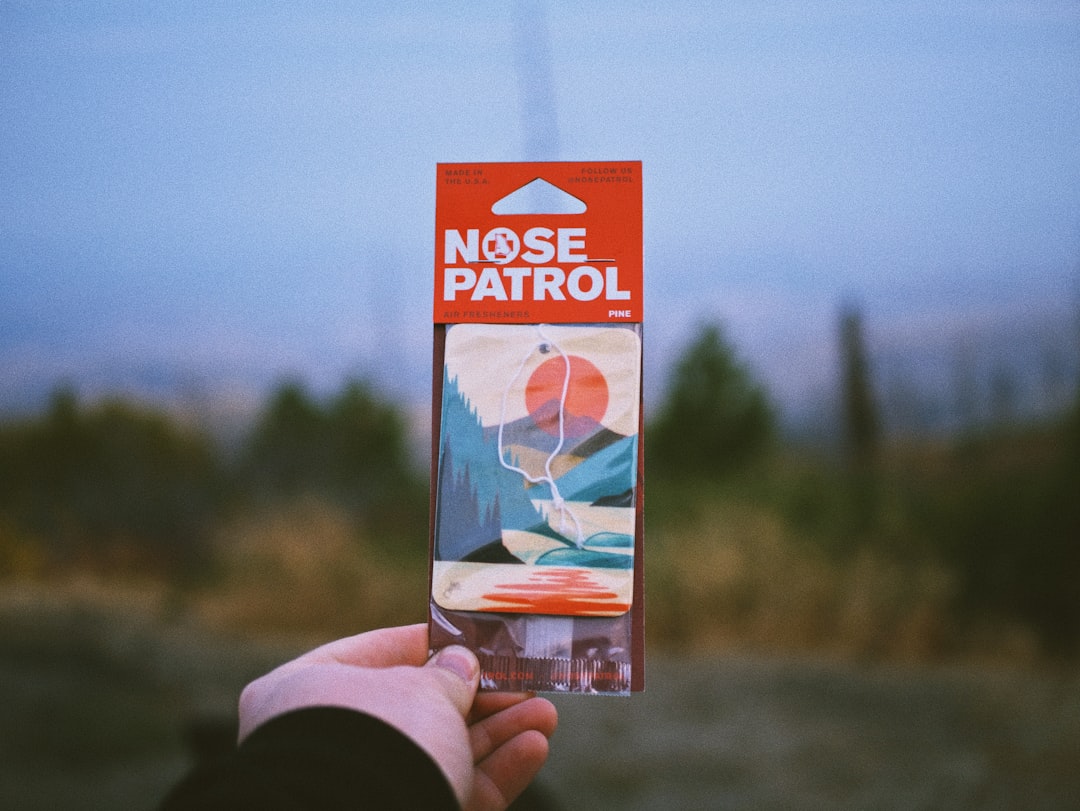 person holding white and orange box