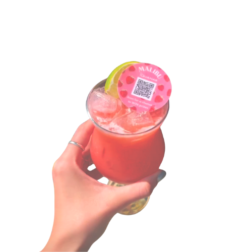 A cocktail with a wafer round topper with the Malibu logo and the campaigns QR code printed. 