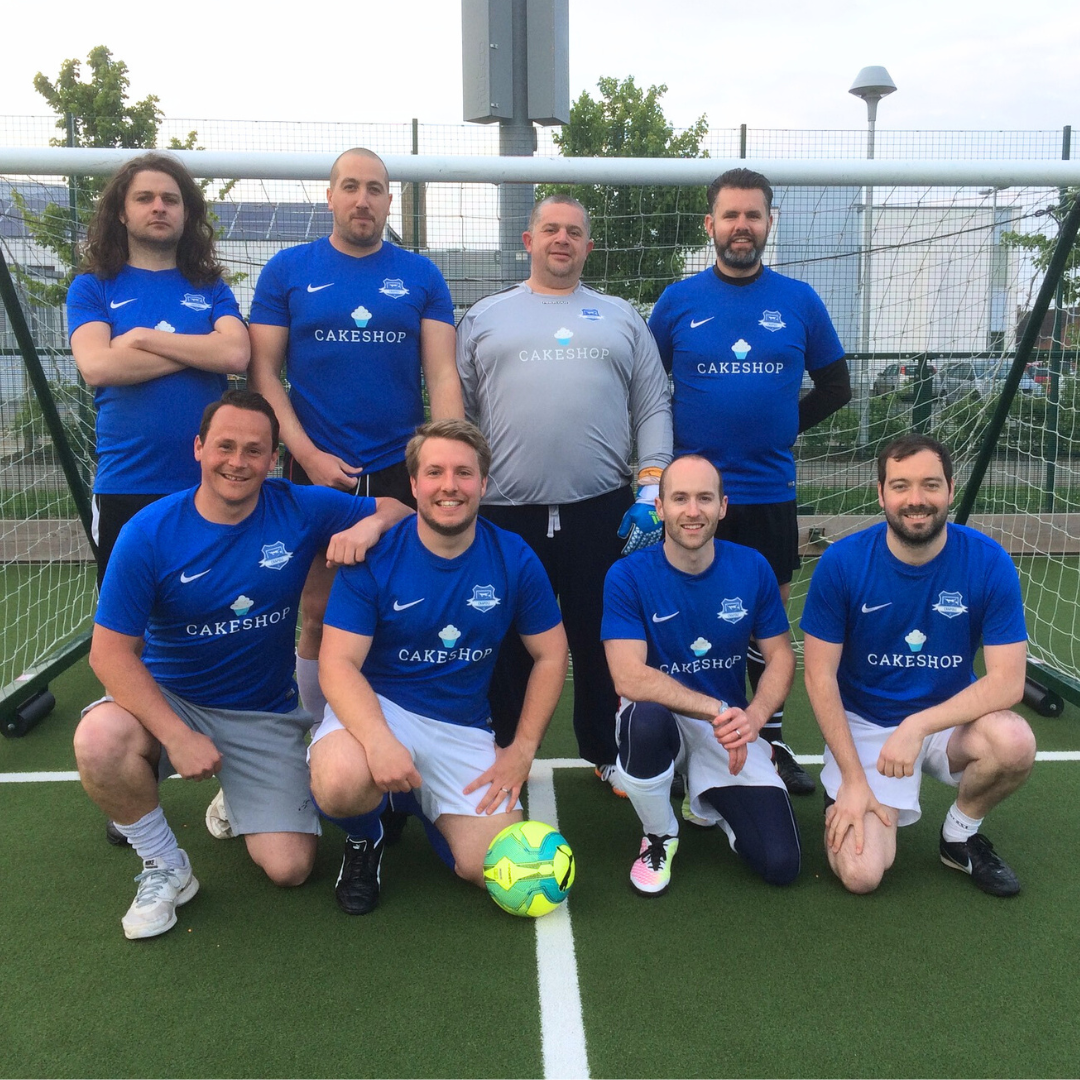 A football team photo from a local team with sponsored Cakeshop shirts.