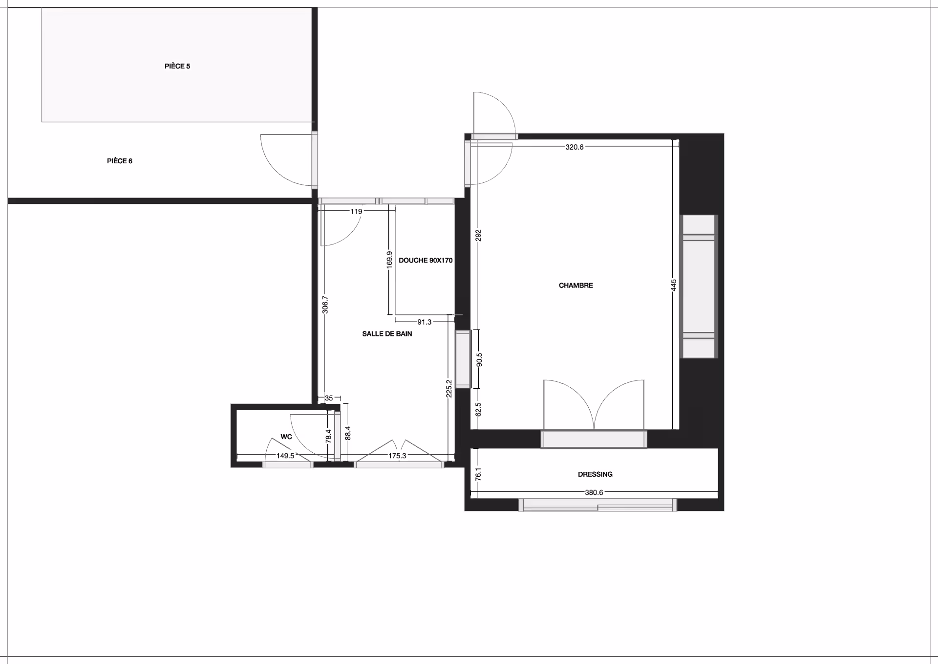 Modern living space with green accent wall, open shelves filled with books, a black chair, a green cushioned floor seat, and glass doors leading to a dining area with wooden chairs.