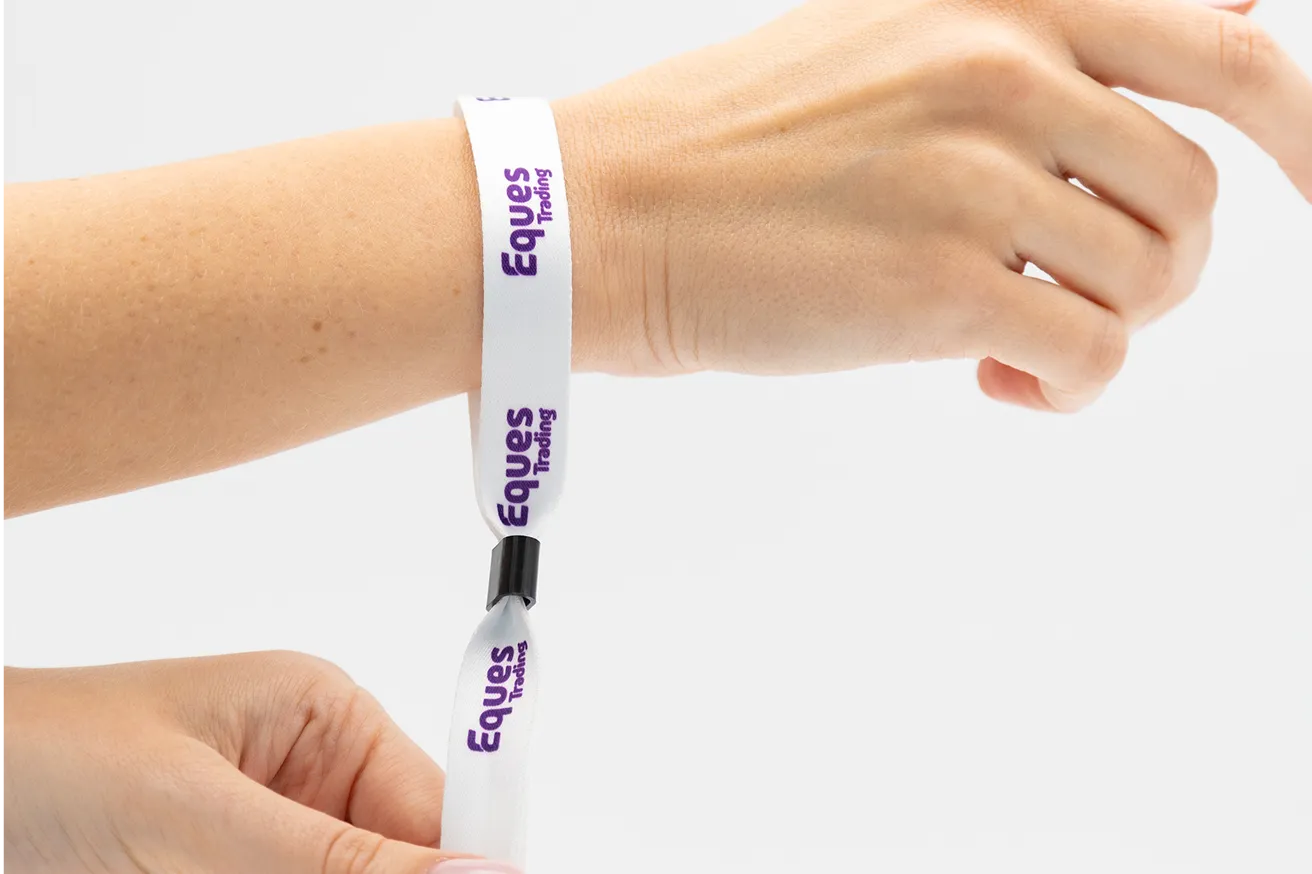 a hand wearing a wristband manufactured by Lanyardy