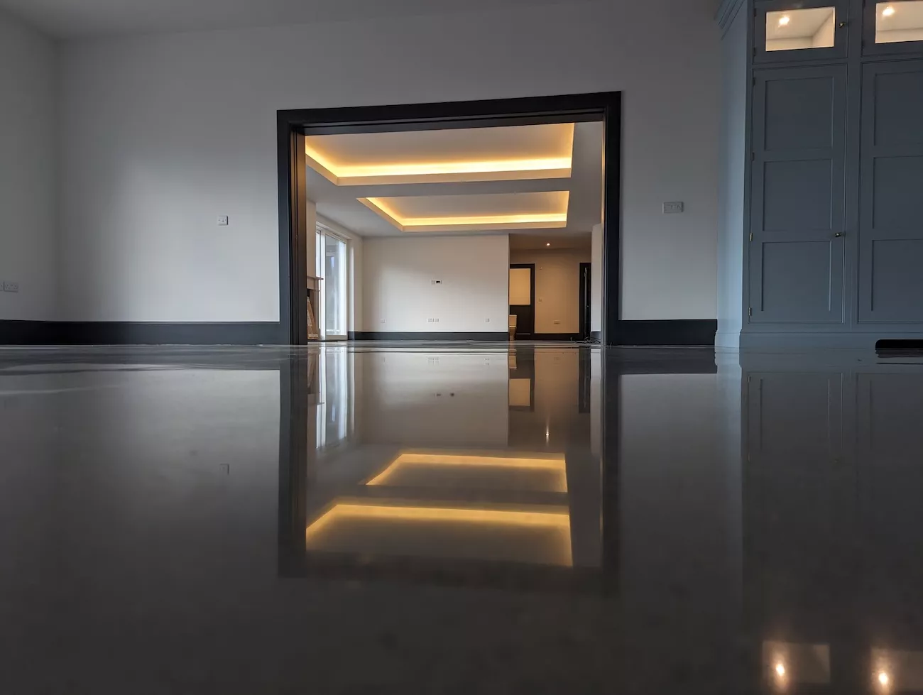 A polished concrete floor installed in a large open living space. 