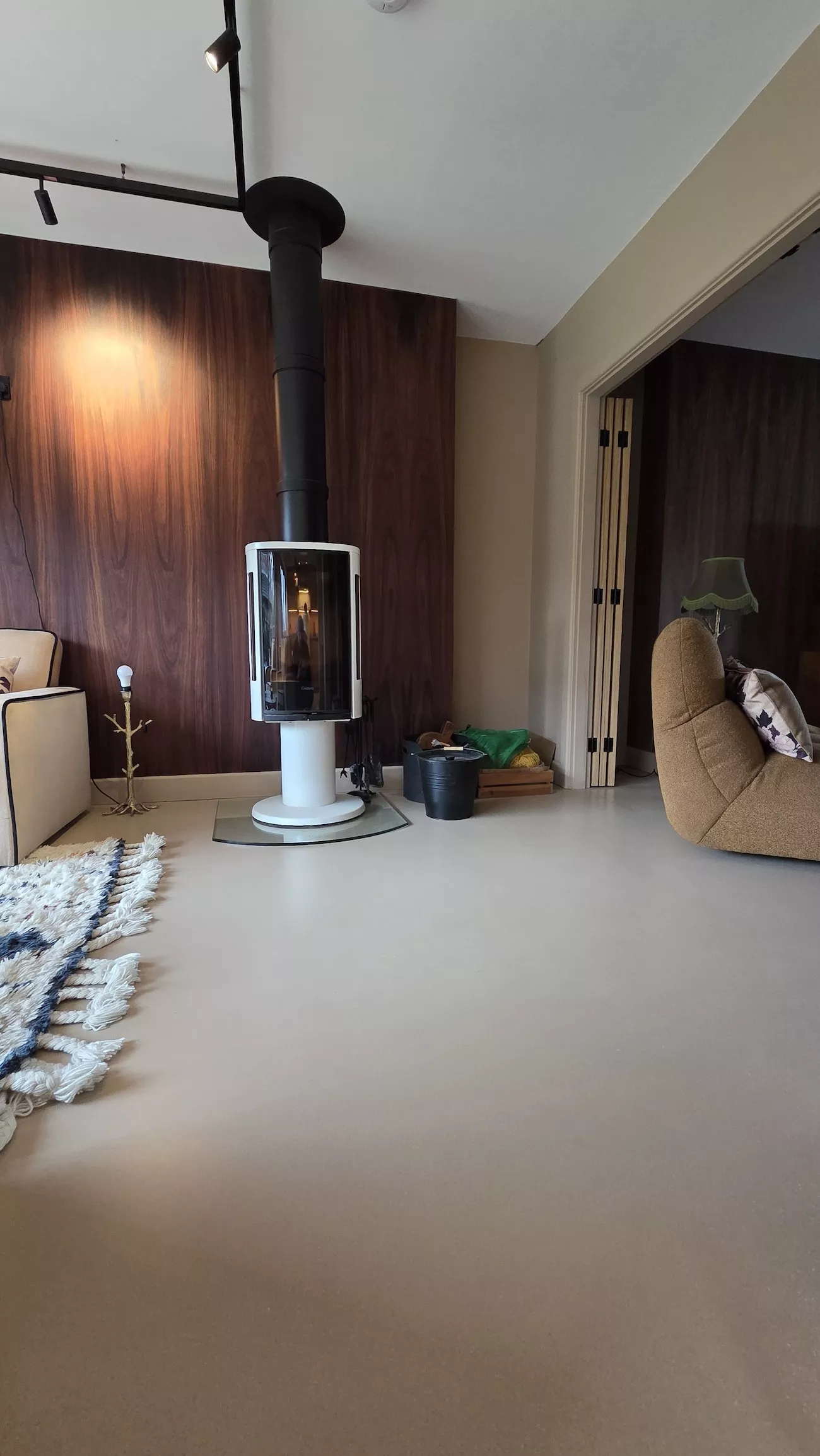 Polished concrete overlay in living room with feature fireplace and seamless concrete overlay flooring