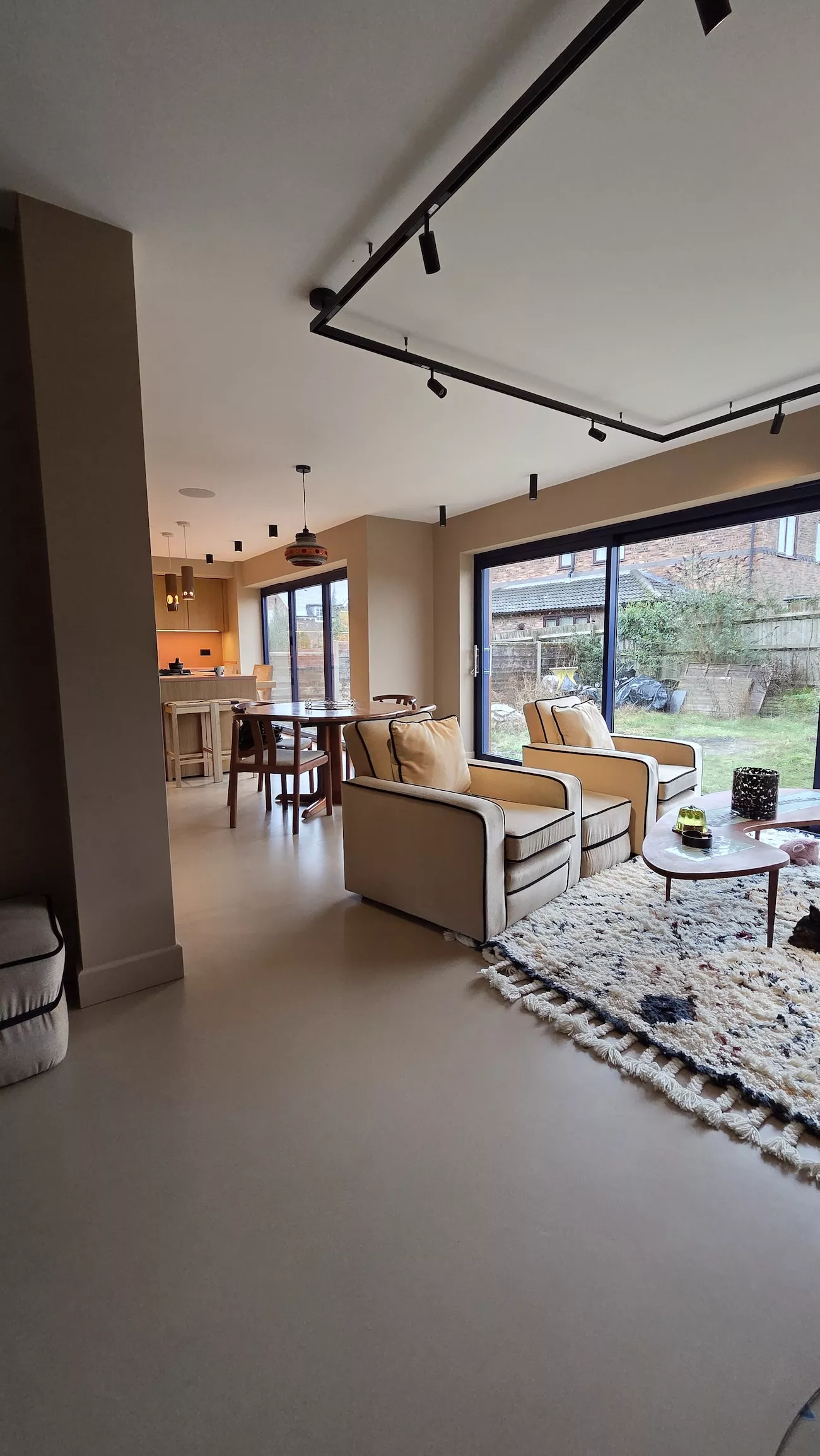 Polished concrete overlay in open plan kitchen with island and large windows concrete overlay flooring