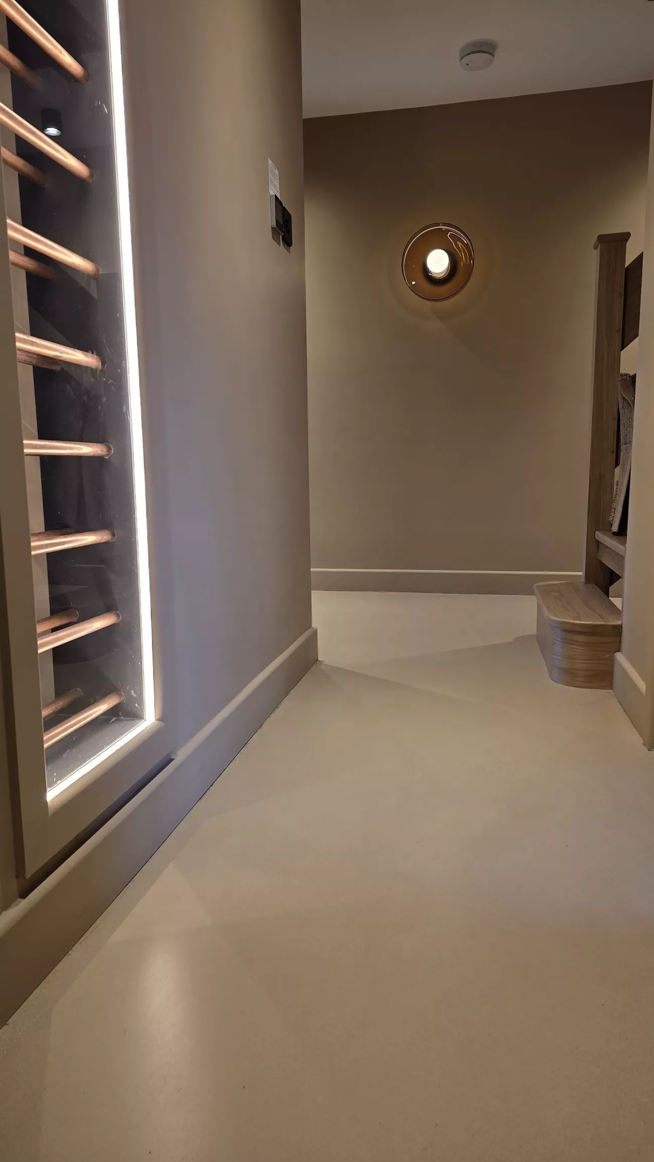 Concrete overlay flooring connecting hallway and living space with polished concrete overlay finish
