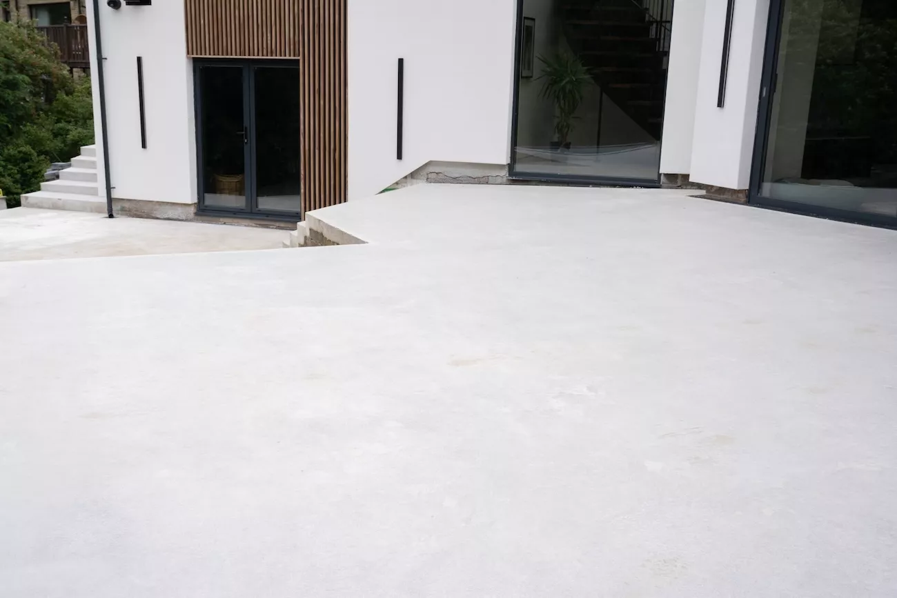 Polished concrete garden floor patio leading to bi-fold doors, UK residential project