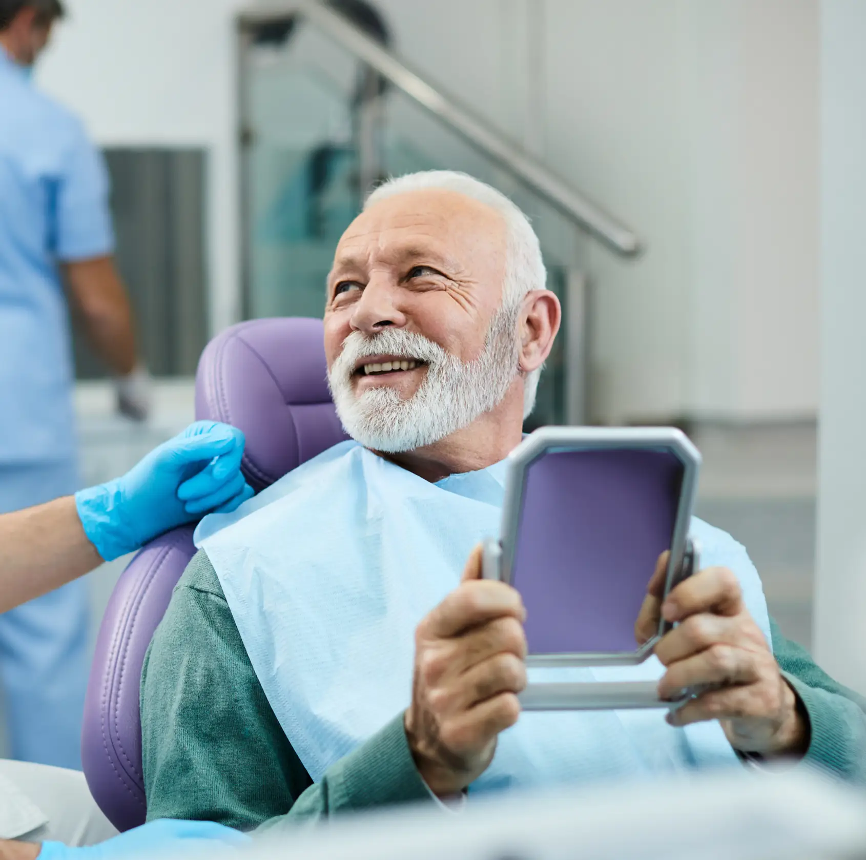 Happy patient looking at the mirror