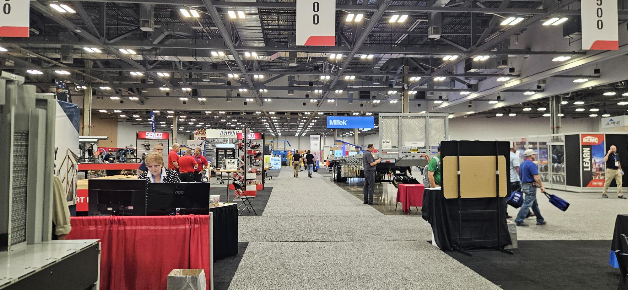 Exhibit aisle at BCMC 2026 with equipment and software booths on both sides