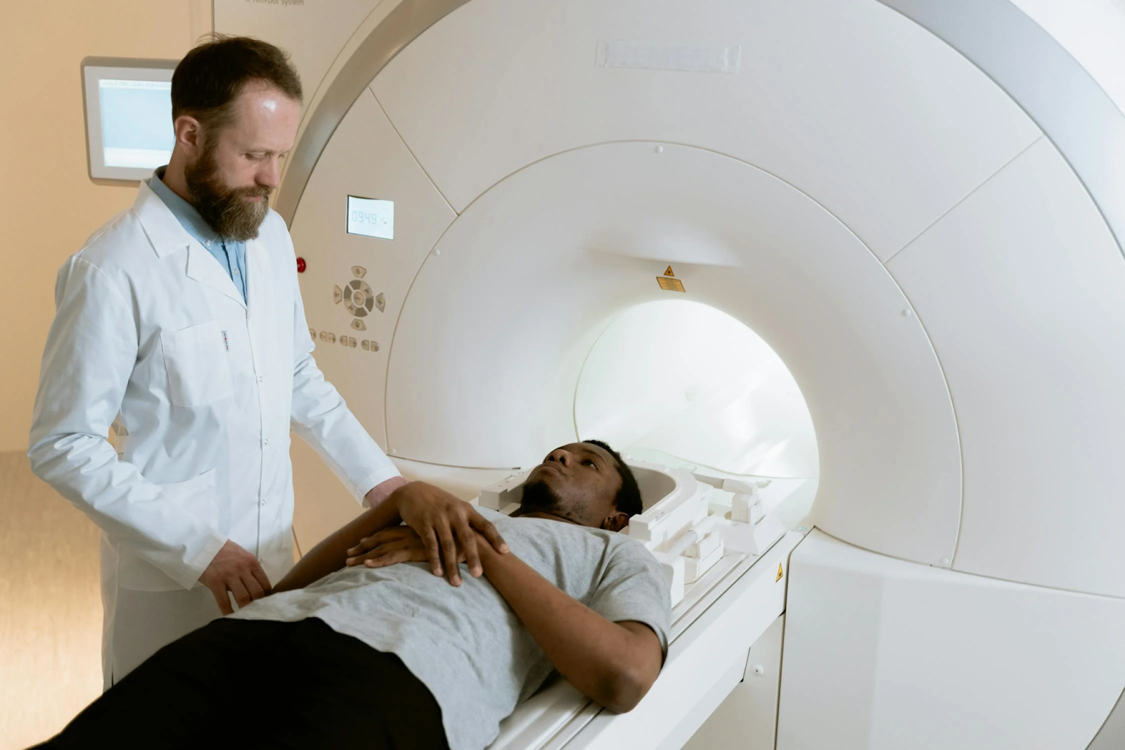 A healthcare professional prepares a patient for an MRI scan.