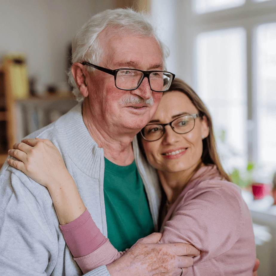 Older man hugging woman