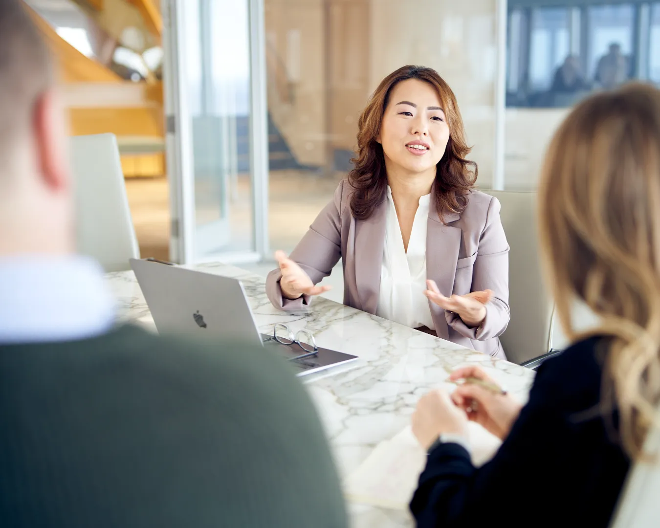 Executive advisor leading a small meeting, discussing strategy, decision-making, and organizational structure.