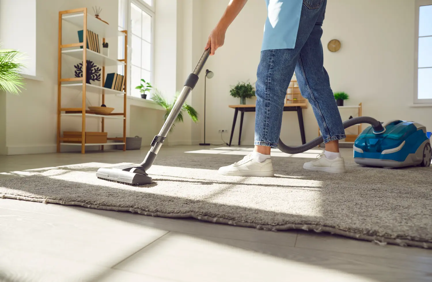 Woman vacuuming the carpet