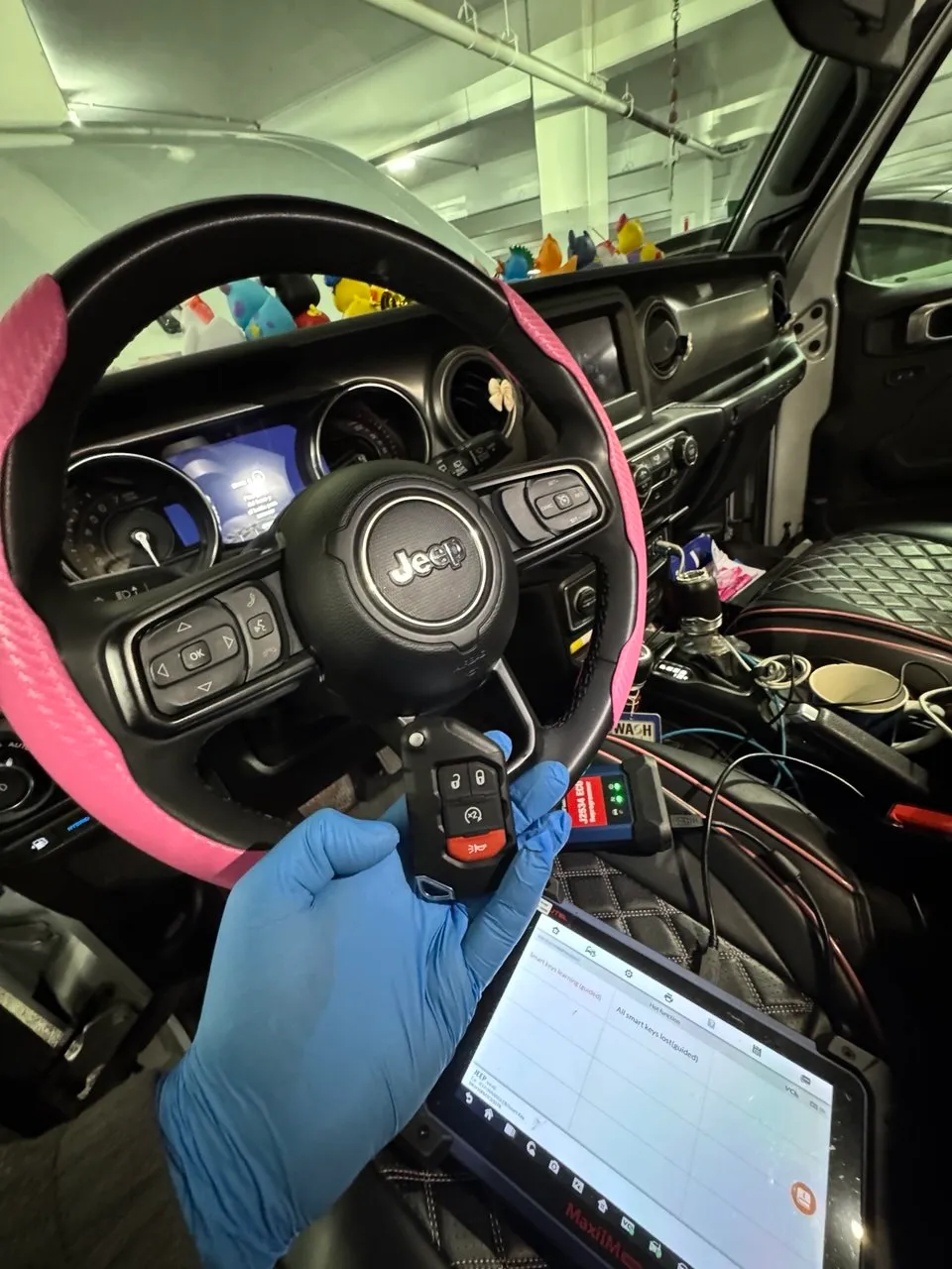 Auto locksmith programming a key fob inside a Jeep in Columbus, OH.