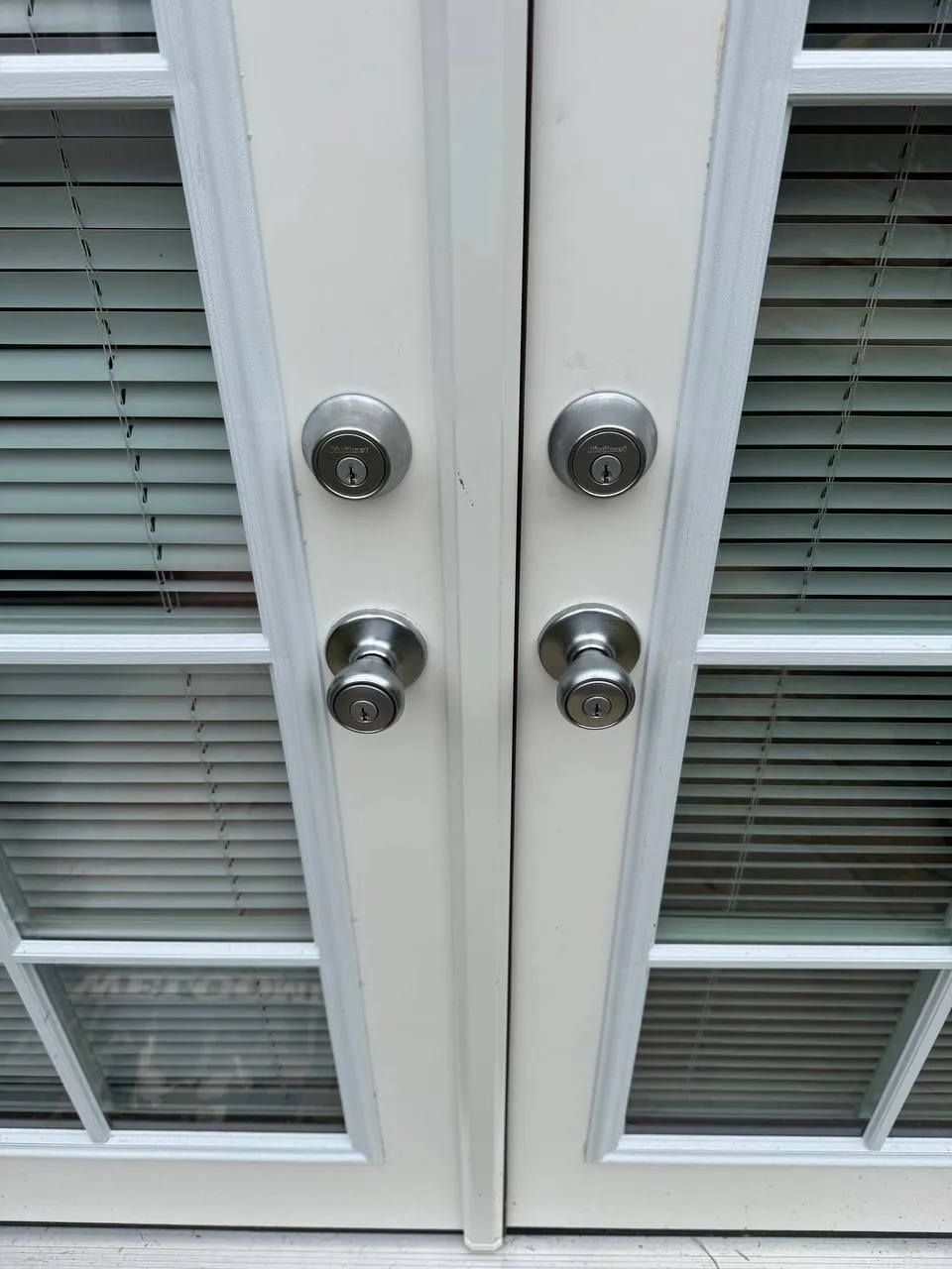 Residential double-door lock and handle installation.