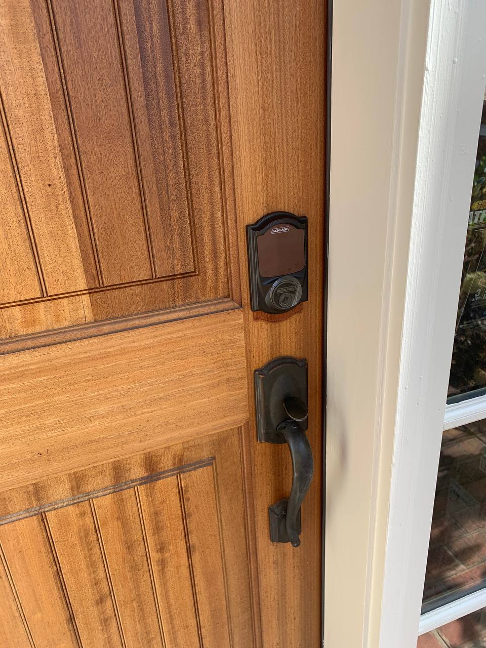 Wooden entry door with newly installed deadbolt and handle set.