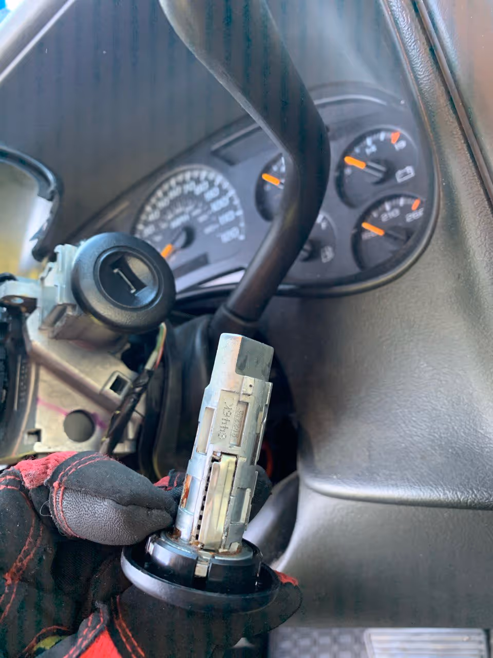 Worn ignition lock cylinder removed from steering column