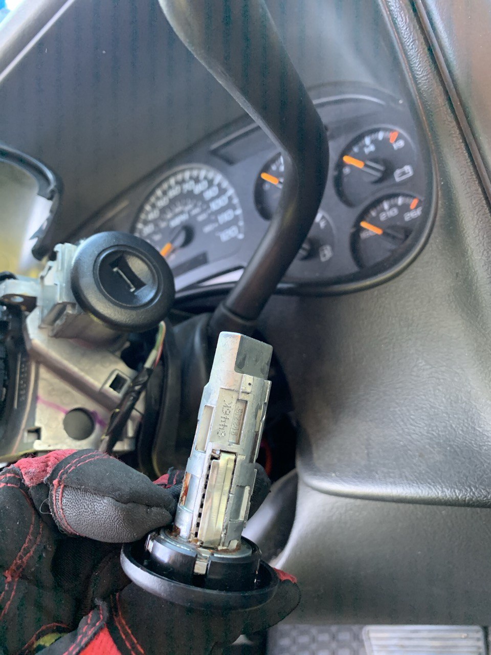 Worn ignition lock cylinder removed from steering column