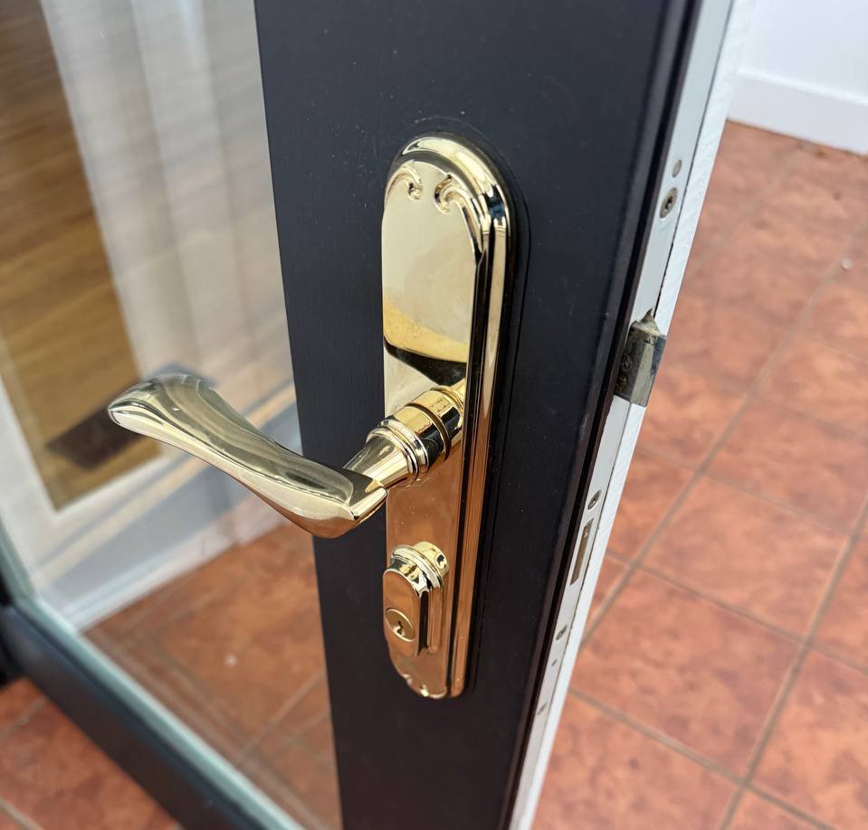 Residential door handle and lock rekeyed by locksmithLocksmith rekeying a door lock cylinder on-site