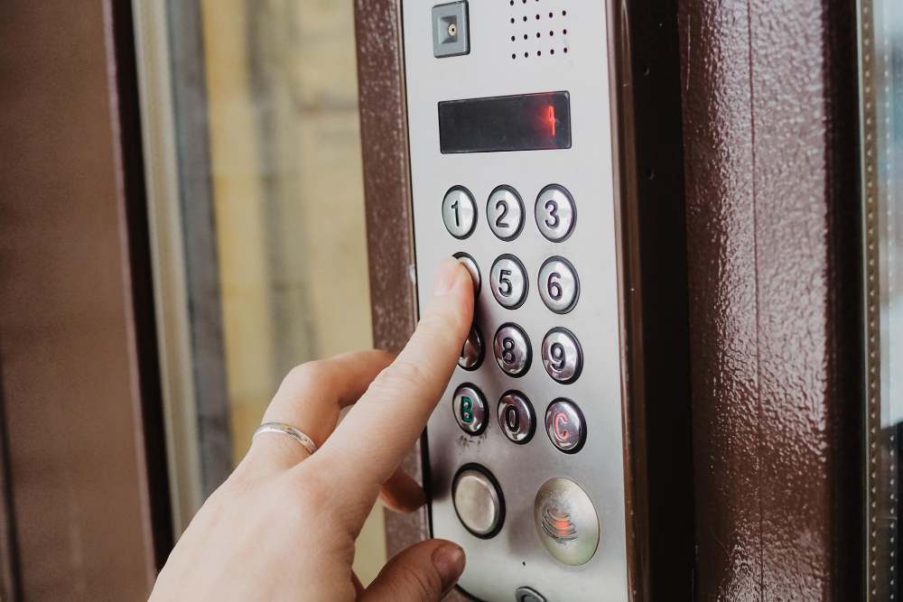 Person entering a PIN on a keypad access control system for keyless entry