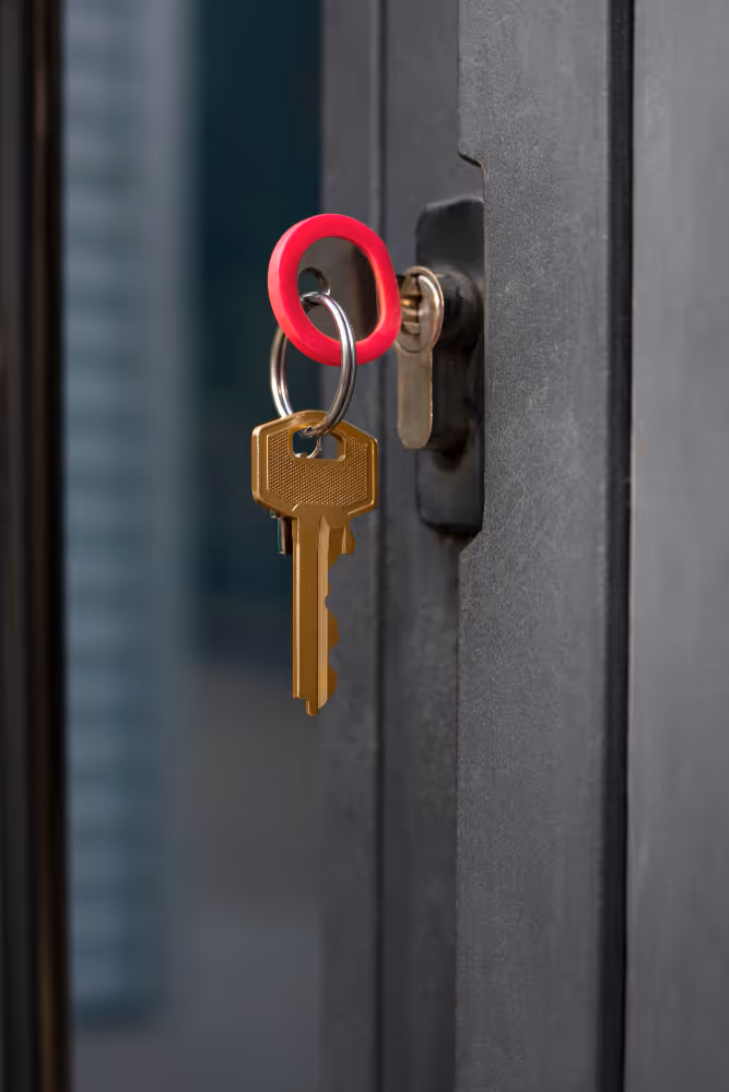 Key inserted into gate lock cylinder close-up