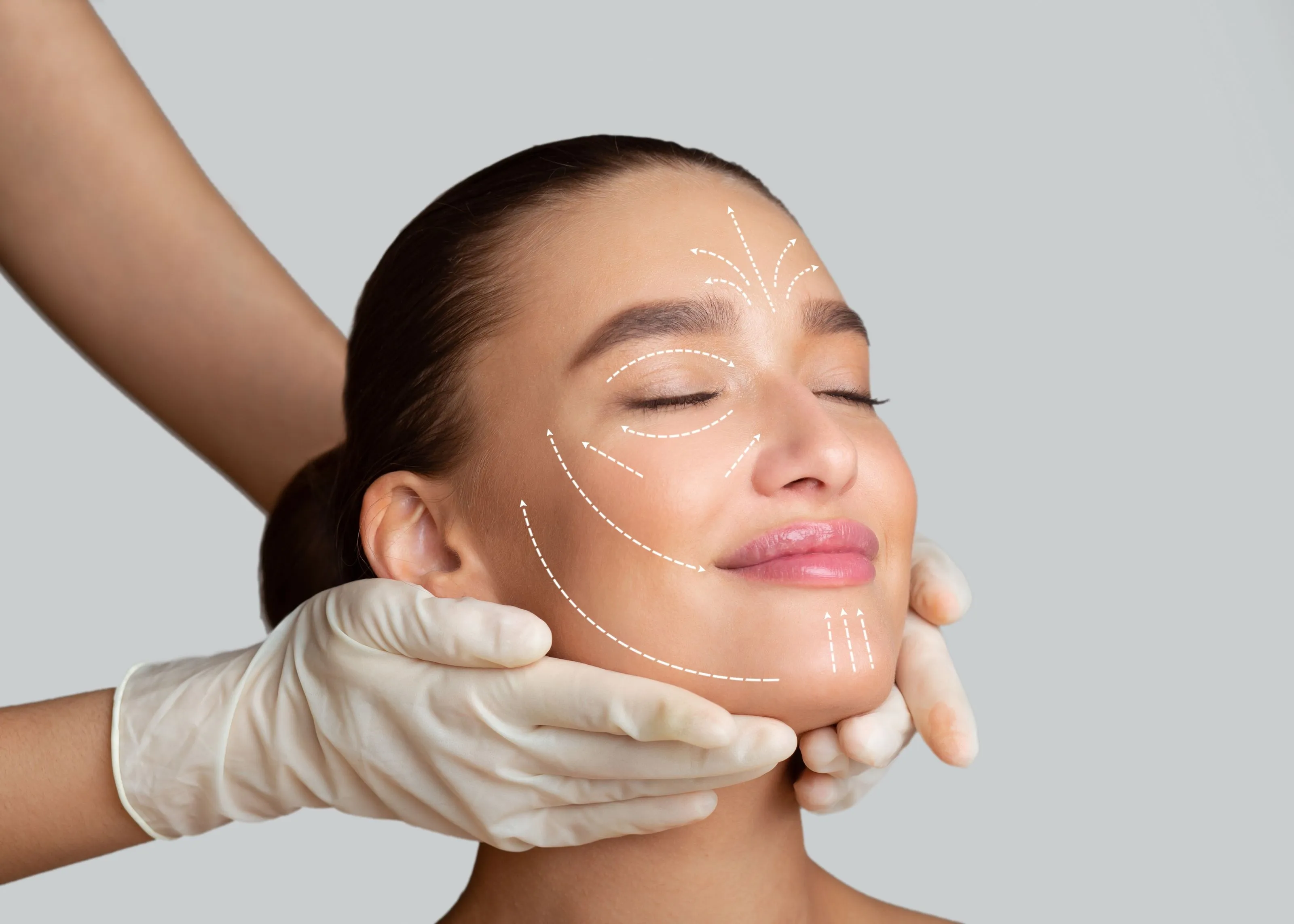 A woman getting a facial lift from a doctor.