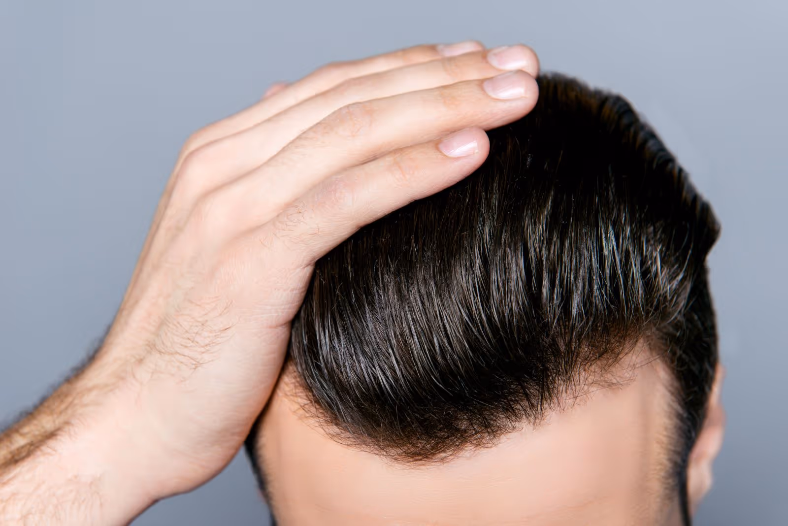 A man with his hand on his head.