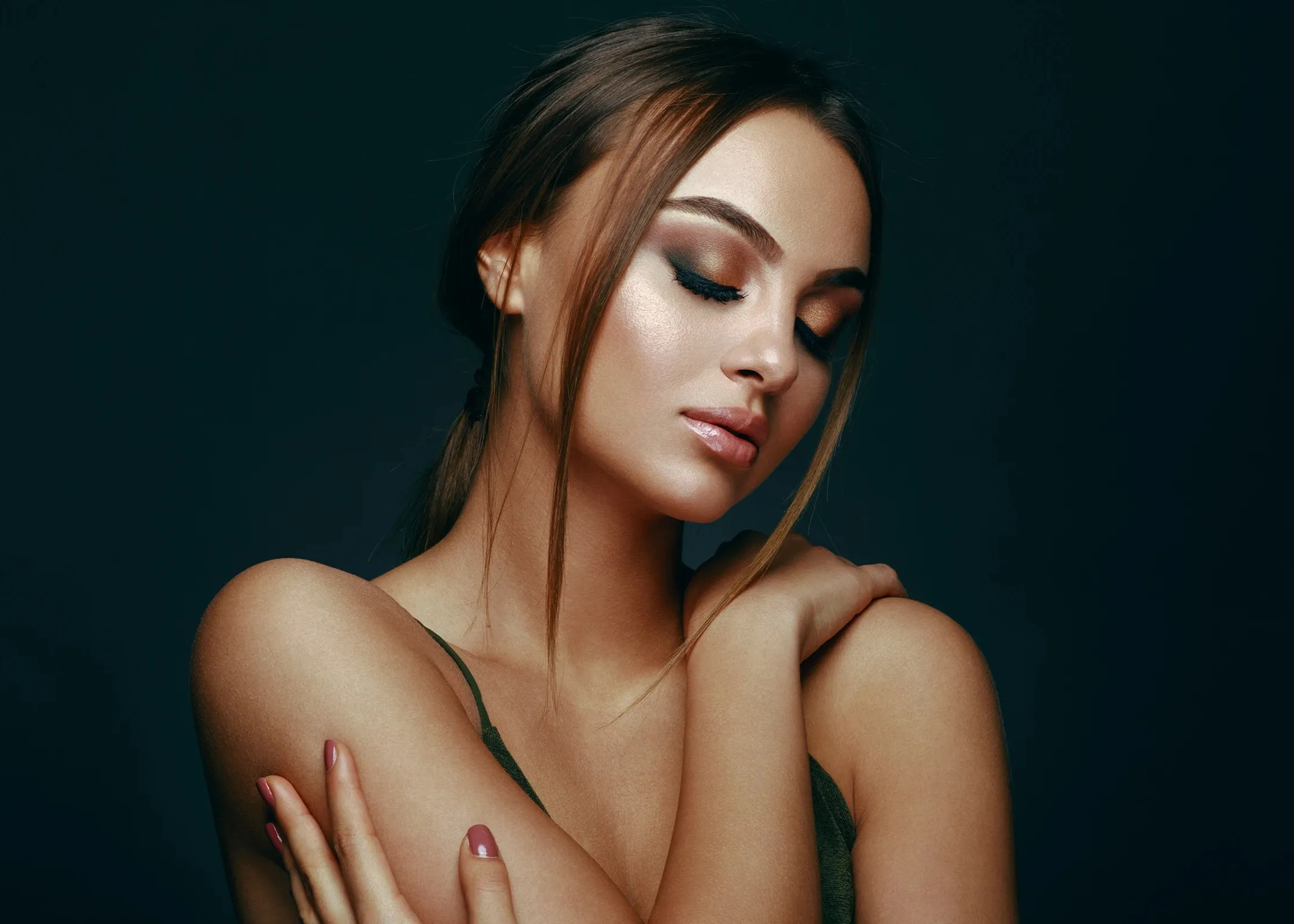 A woman with her arm around her chest.