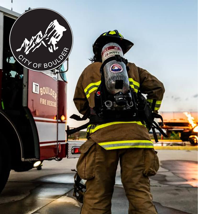 Boulder Fire Rescue firefighter at dusk preparing equipment