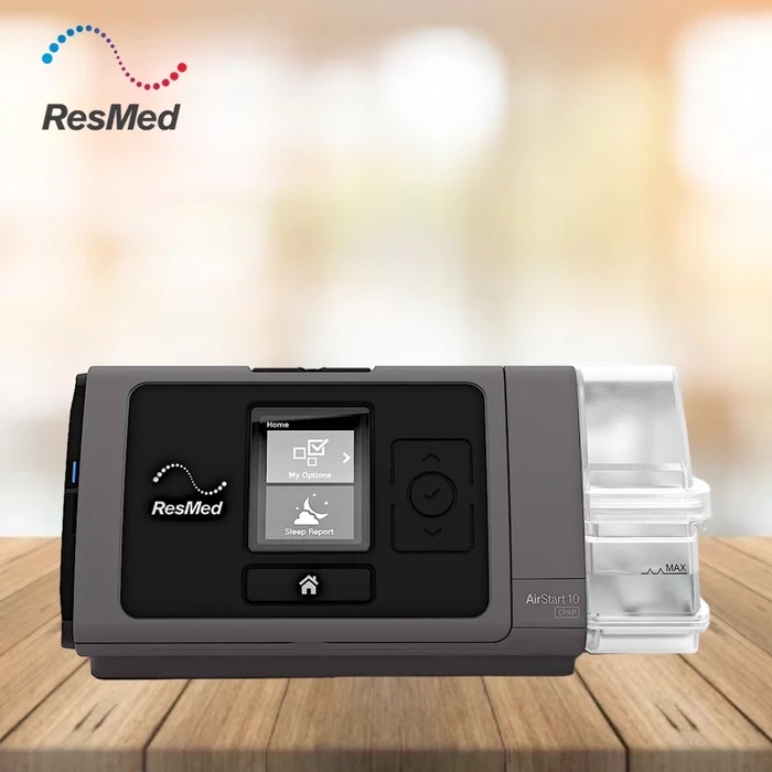 resmed airstart 10 auto cpap machine on wooden table for sleep apnea therapy