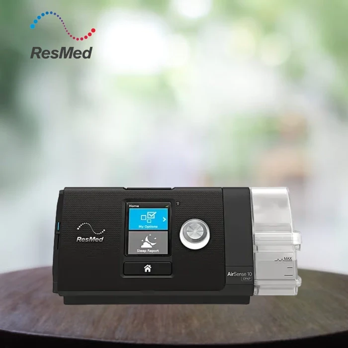 ResMed AirSense 10 Elite Manual CPAP machine in black with humidifier, on a wooden surface, for sleep apnea therapy

