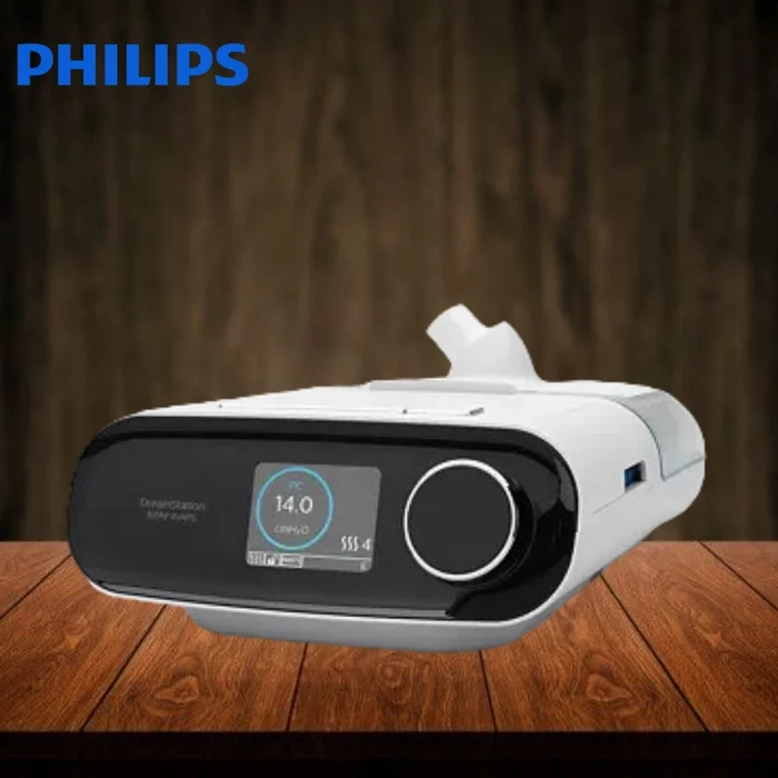 Philips DreamStation Auto CPAP machine in white with a digital display, on a wooden table, for sleep apnea therapy

