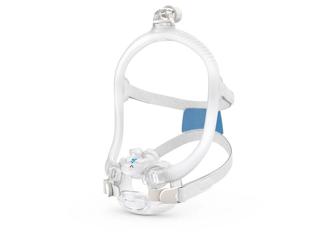 A white and transparent nasal CPAP mask with a light blue cushion, shown against a plain white background. A red and white striped circular 'Red Dot Design Award' logo is in the bottom right corner.