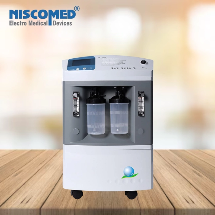 Niscomed dual flow oxygen concentrator on wooden table for medical use