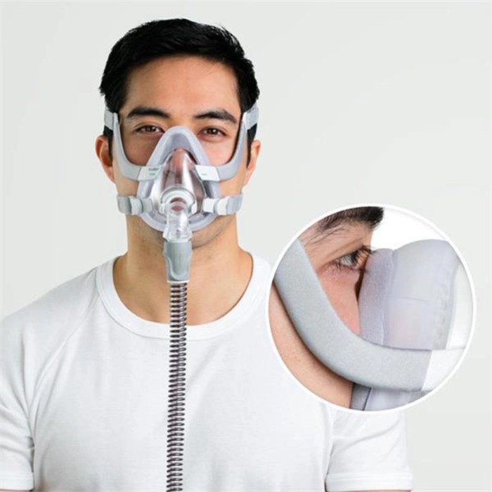 Man wearing ResMed CPAP full face mask with headgear for sleep apnea therapy