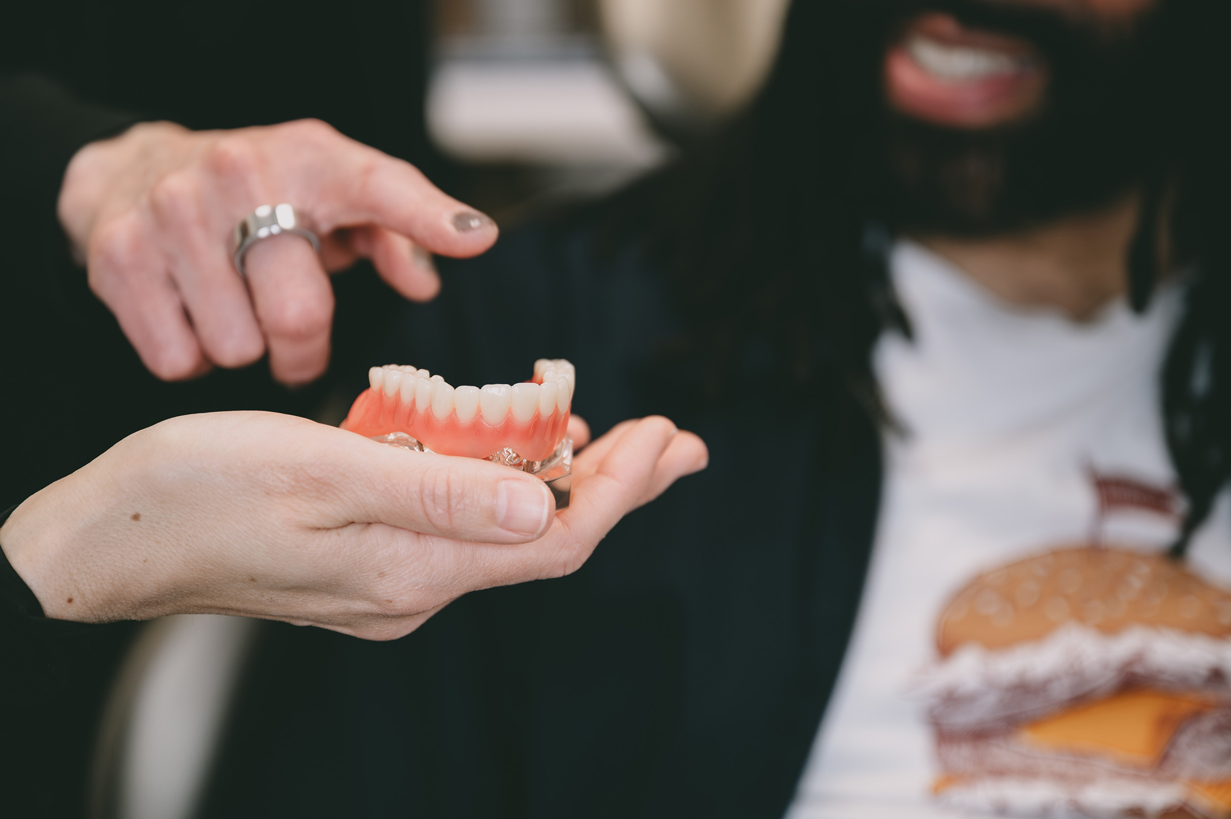 Dentist showing a patient an x-ray at a dental office room. 