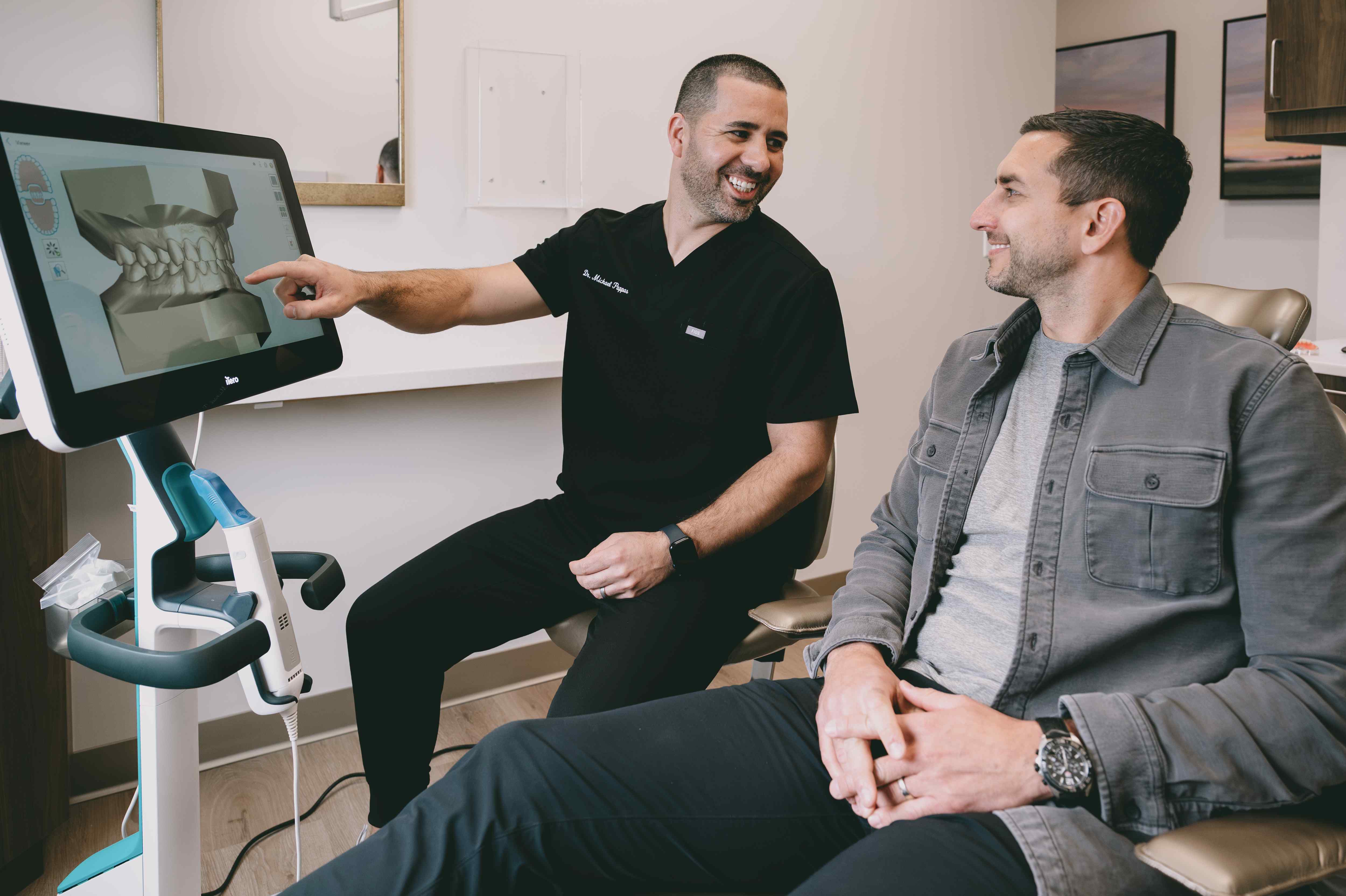 Our dentists at Jerome Dental explaining the best cosmetic approach to improve a patient's smile
