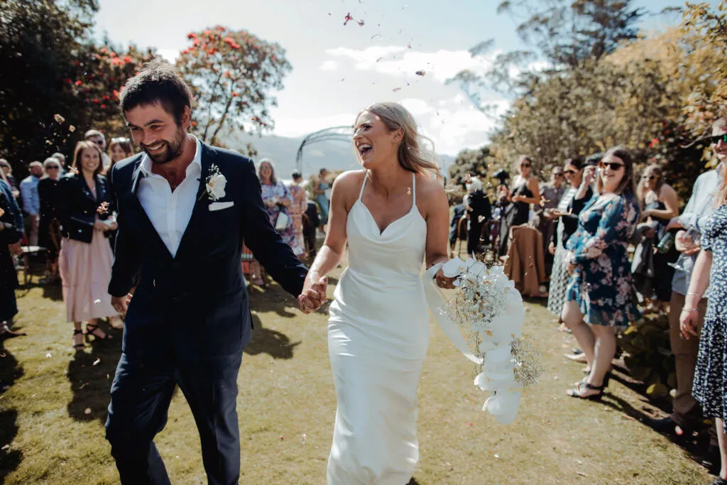 Newly weds walk down isle at Glenfalloch Gardens in Dunedin.