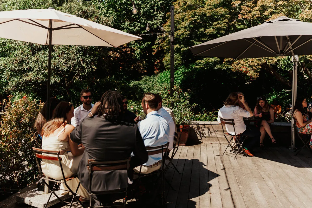 Guests enjoy a meal and drink on the deck at Glenfalloch Gardens