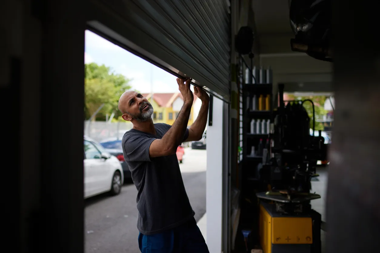 A technician inspecting a garage door for repair