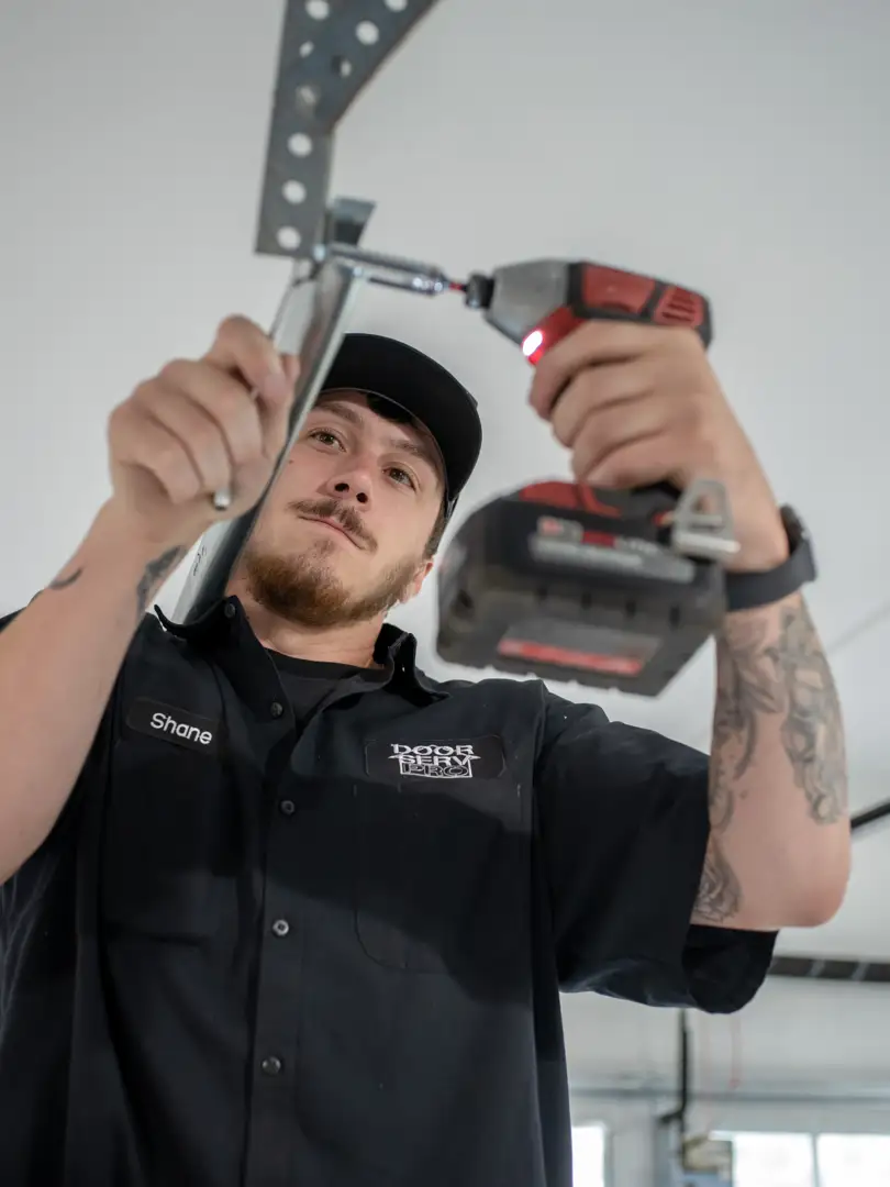 Professional installer mounting heavy-duty steel ceiling racks in a modern garage - garage storage solutions contractor in Professional installer mounting heavy-duty steel ceiling racks in a modern garage - garage storage solutions contractor in