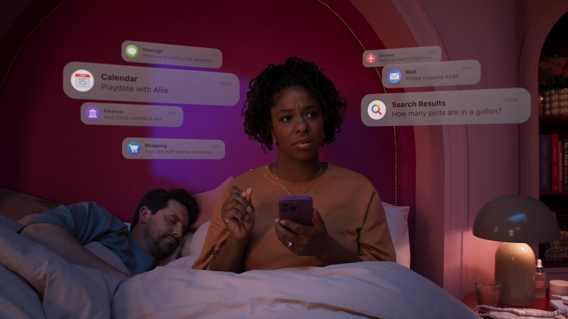 Picture of people in bed surrounded by floating screen notifications